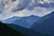 The storm is comming over the peaks of the mountain. Dramatic sky