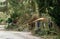 Storm damage of a blown over tree lying on a wooden garden fence