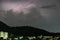 Storm lightning strikes in mountains during a thunderstorm at night. Beautiful dramatic view