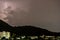 Storm lightning strikes in mountains during a thunderstorm at night. Beautiful dramatic view