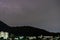 Storm lightning strikes in mountains during a thunderstorm at night. Beautiful dramatic view