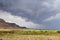 Storm over mountain Masada in Judean desert, Israel. dark blue sky above the mountain next to dead sea