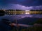 Storm overcast with thunderclouds and the glow of lightning. Landscape with city of Slavonski Brod in Croatia, calm river Sava and