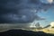 Storm and rain cloud moving past the mountain