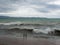 Storm on the resort coast. Storm waves are breaking on the pier. Dramatic cloudy sky and strong wind