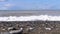 Storm on the sea. Bottom view of the stony shore. Huge waves are crashing on the beach