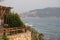 Storm at sea on Cleopatra Beach, foam waves, coastal cafe above the cliff, wooden fence against the background of the