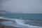 Storm on the sea, high foamy waves, a fisherman among the foamy waves on the beach in Alanya, Turkey.