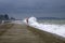 Storm on the sea. Pier flooded wave.