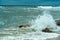 Storm at sea, waves crashing on rocks, stormy sky and sea