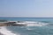 Storm on the sea, waves of foam against the background of the beach pier, Alanya, December 2023.