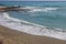 Storm on the sea, waves of foam against the background of the beach pier, Alanya, December 2023.