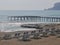 Storm on the sea, waves of foam against the background of the beach pier, Alanya, December 2023.