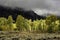 Storm showers cross the landscape in the Teton mountains.