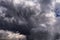 Storm sky with dark gray black epic cumulus clouds background texture, hurricane with thunderstorm, cyclone. Black and white