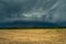 Storm supercell in gray sky over agricultural fields, Czulczyce, Poland