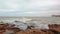 Storm Surge Waves Spill Over Harbor Sea Wall.