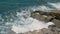 Storm waves in the ocean Rocky shore in the ocean with stormy and foamy waves.