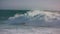 Storm waves rolling ocean surface making white foam. Powerful surf barreling in