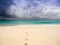 Stormy beach with footprints on the sand