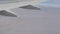 Stormy black clouds float across sky against the background of the wing of the airplane