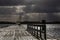 stormy cloud over a pier and lake