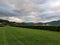 Stormy Clouds above Smoky Mountains in North Carolina, green grass below