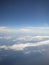 The stormy clouds shined from above with the sun. View from aeroplane