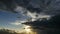 Stormy clouds timelapse with sun shining. Dramatic rain clouds.