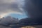 Stormy cloudy sky wide panorama, dramatic dark blue thunderclouds, gale cloudscape, gray cumulus rain clouds panoramic view,