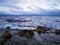 Stormy coastline with gloomy cloudy sky