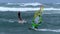 Stormy competition between seagull and windsurfers