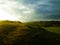 Stormy couds and sunset sky over fields