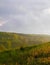 Stormy couds and sunset sky over fields