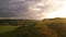 Stormy couds and sunset sky over fields