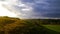 Stormy couds and sunset sky over fields