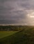 Stormy couds and sunset sky over fields