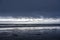 Stormy evening landscape coast of the Northwest Pacific Ocean with the remains of an old marina and flying albatrosses