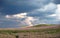 Stormy fields with flowers and clouds