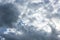 Stormy gray and white cumulus clouds on blue sky