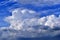 A stormy landscape with blue Cumulus clouds on the horizon