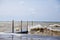 Stormy Michigan Lake Shore with Dilapidated Pier Amid Turbulent Waves