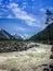 Stormy mountain river at the foot of the Altai snow-capped mountains. Concept of travel and extreme relaxation.