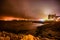 Stormy night over an urban coastline