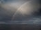 Stormy rainbow over a lake