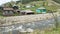 A stormy river and bright wooden rural houses in the Altai. Summer trip to Siberia in Russia