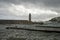 Stormy sea, high waves in old fisherman`s harbour with lighthouse in Cassis, Provence, France