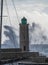 Stormy sea, high waves in old fisherman`s harbour with lighthouse in Cassis, Provence, France