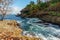 Stormy sea in a rocky Cove with palm trees