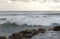 Stormy sea during a storm near Paphos, Cyprus. The waves crash against the rocks that protrude from the sea. The droplets fly up